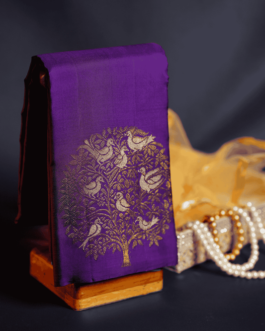 Violet Borderless Kanchipuram Pure Silk Saree adorned with Elegant Tree Bird Butta Motifs and Opulent Two Gram Gold Zari