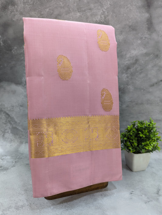 Luxurious pink and gold silk saree featuring stunning gold border