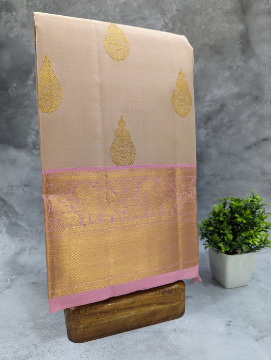Pinkish cream designer silk sarees online with intricate Tilagam Butta motifs