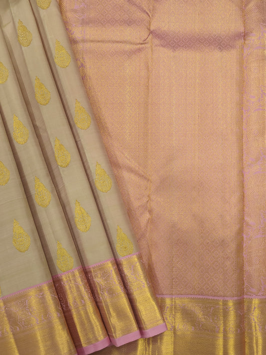 Pinkish cream designer silk sarees online with intricate Tilagam Butta motifs