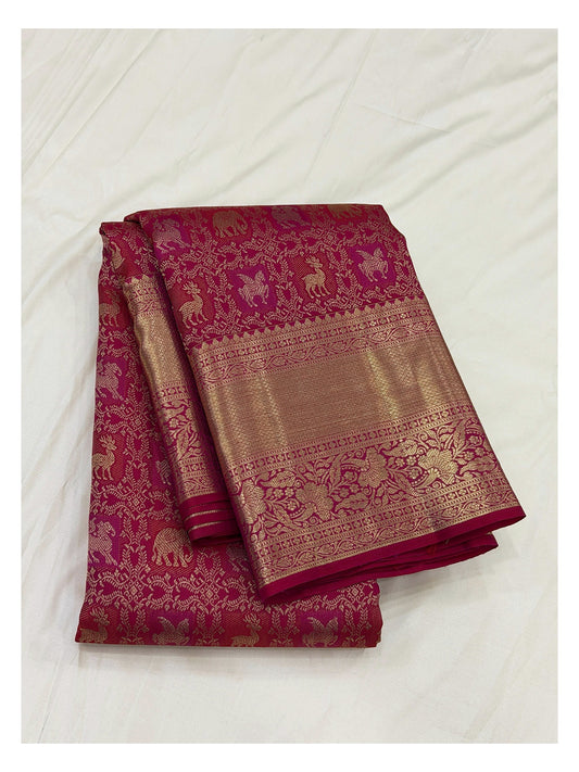Folded deep magenta handwoven Kanchipuram silk saree with gold-toned woven motifs and broad floral border