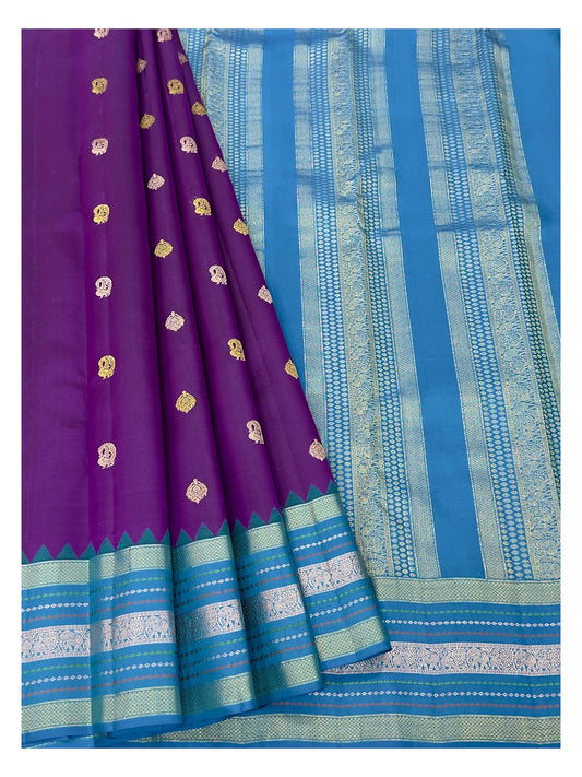 Draped view of purple Kanchipuram silk saree with teal blue zari-style pallu