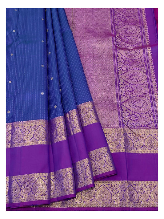 Royal blue handwoven Kanchipuram silk saree drape showing the magenta contrast pallu and woven border details