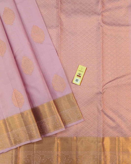 Beautiful light pink floral buttas adorn these traditional Kancheepuram silk sarees with self-designed borders