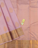 Beautiful light pink floral buttas adorn these traditional Kancheepuram silk sarees with self-designed borders