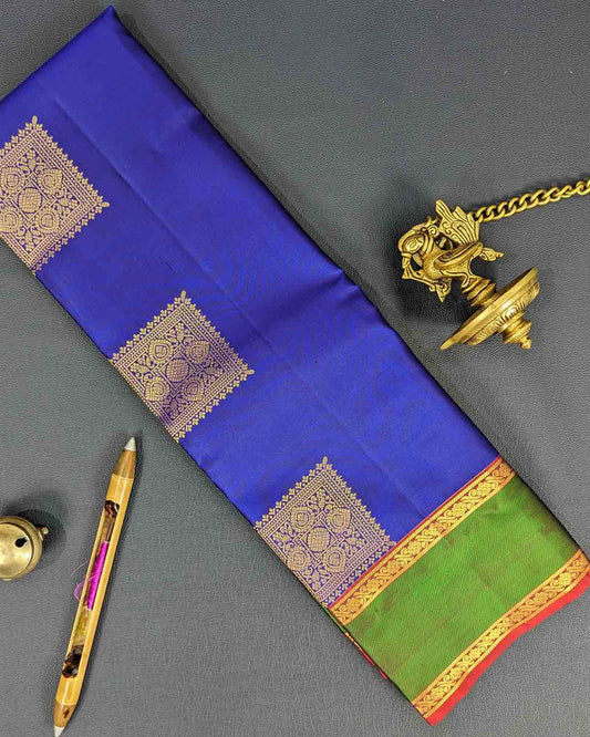 Timeless blue Kancheepuram silk saree with square buttas and a dual-color intricate border