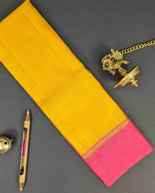 Yellow and pink silk sari with gold border, perfect for a festive occasion