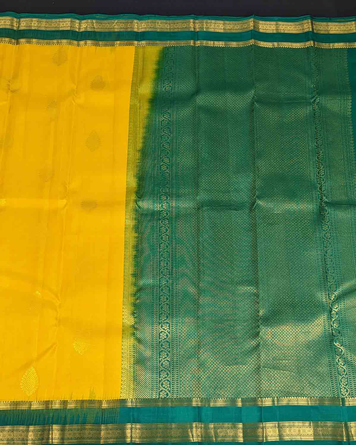 Bright yellow Kancheepuram silk sarees with contrasting border and intricate pallu