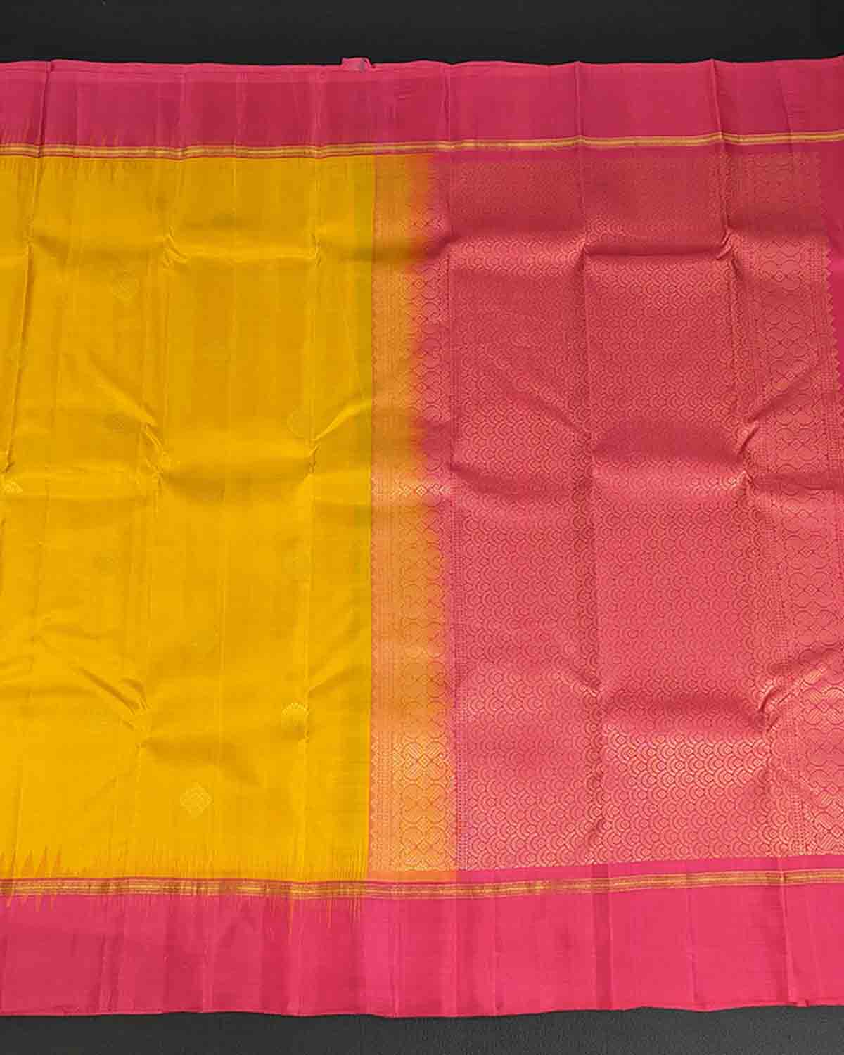 Vibrant yellow and pink silk sari featuring a shimmering gold border
