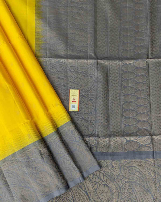 Yellow Kanchipuram soft silk saree with mango motifs, Annapakshi buttas, and paisley zari border