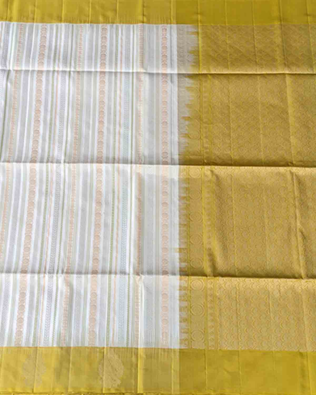 Pastel beige Kanchipuram silk sarees with striped body and paisley zari border