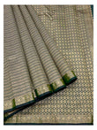 Deep green Kanchipuram silk saree with diamond-pattern pallu and floral border