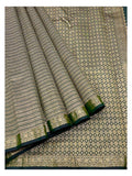 Deep green Kanchipuram silk saree with diamond-pattern pallu and floral border