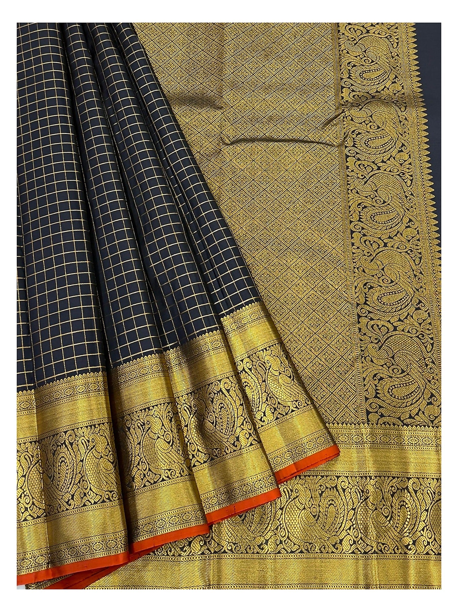 Detailed view of the handwoven saree border and pallu with gold-toned woven peacock motifs and black checked pleats