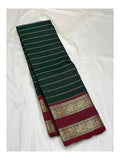 Handwoven Kanchipuram silk saree in deep green with maroon peacock border, folded front view