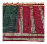 Handwoven Kanchipuram silk saree with deep green striped body and maroon pallu spread out
