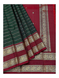Close view of deep green body, maroon pallu and gold-toned peacock border on handwoven Kanchipuram silk saree