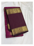Handwoven Kanchipuram silk saree in deep magenta with plum pallu and broad peacock zari border