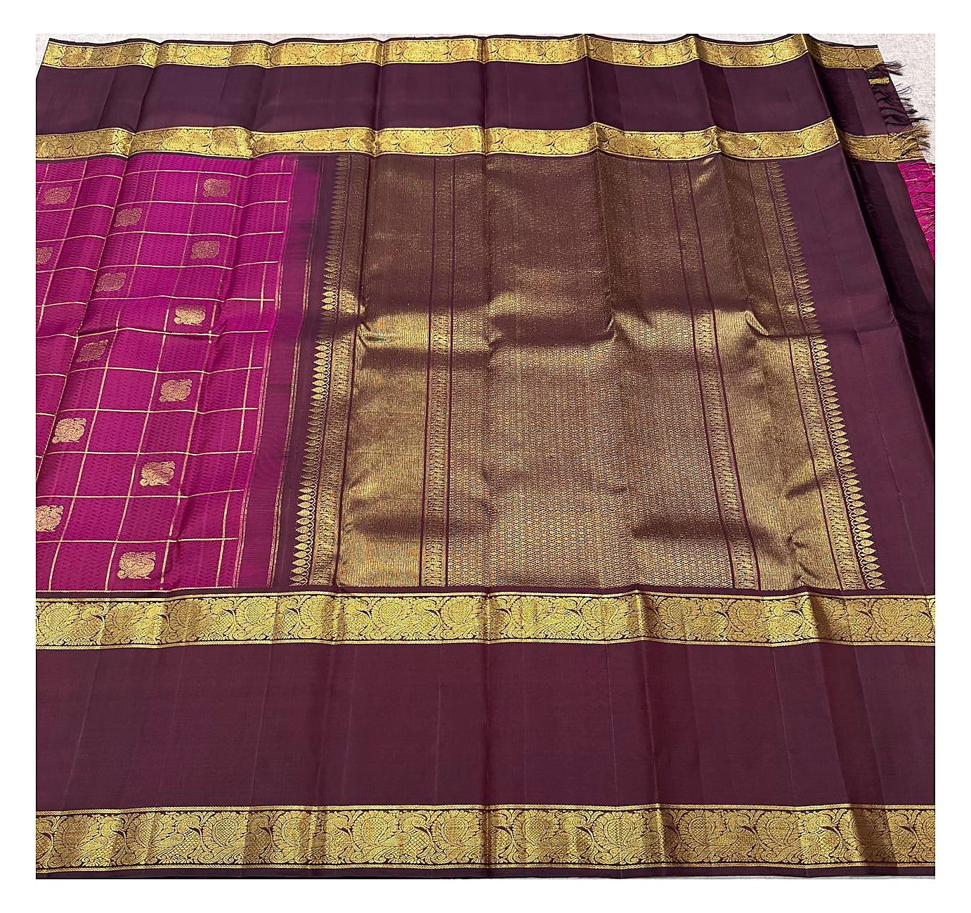 Full drape view of the handwoven Kanchipuram silk saree with deep magenta checked body and rich plum zari pallu