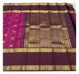 Full drape view of the handwoven Kanchipuram silk saree with deep magenta checked body and rich plum zari pallu