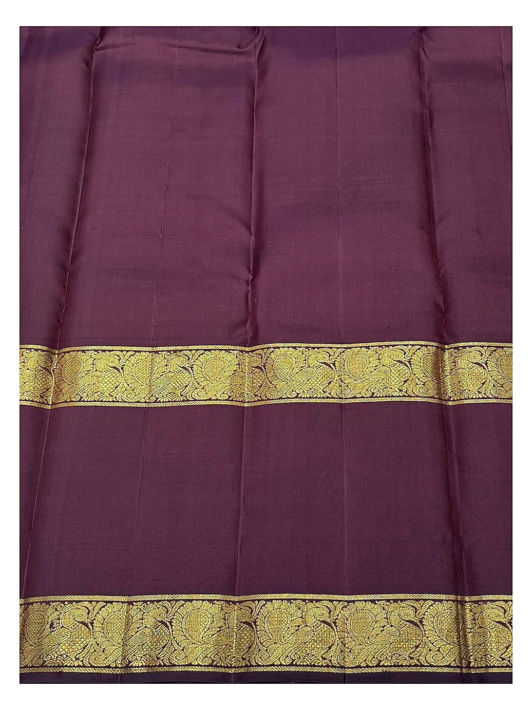 Close view of the plum section with broad peacock-style woven zari border