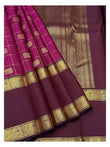 Draped view showing the deep magenta checks, plum zari pallu, and peacock-style border