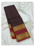 Full folded view of the deep plum handwoven Kanchipuram silk saree with maroon contrast border and gold-toned woven detailing
