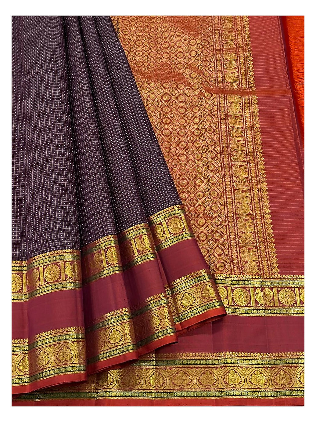 Detailed view of the saree showing the deep plum body, maroon border, and richly woven gold-toned pallu