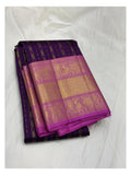 Folded deep purple handwoven Kanchipuram silk saree with magenta and gold-toned elephant motif border