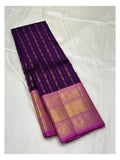 Deep purple Kanchipuram silk saree laid out to show fine woven stripes and broad magenta motif border