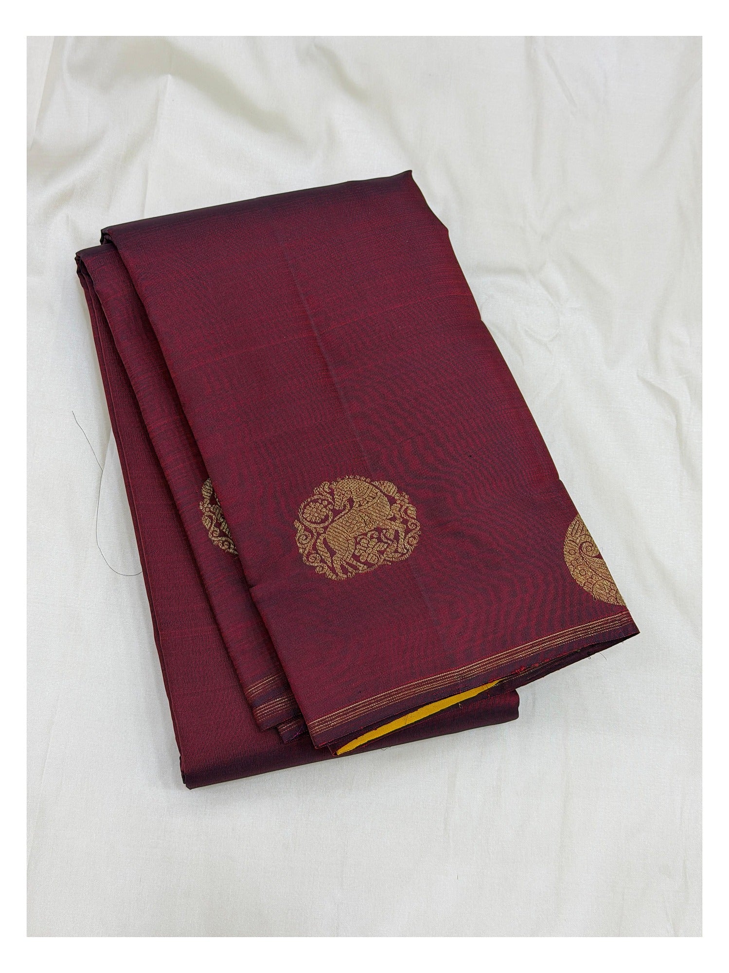 Handwoven Kanchipuram silk saree in deep wine with gold-toned elephant-style motifs