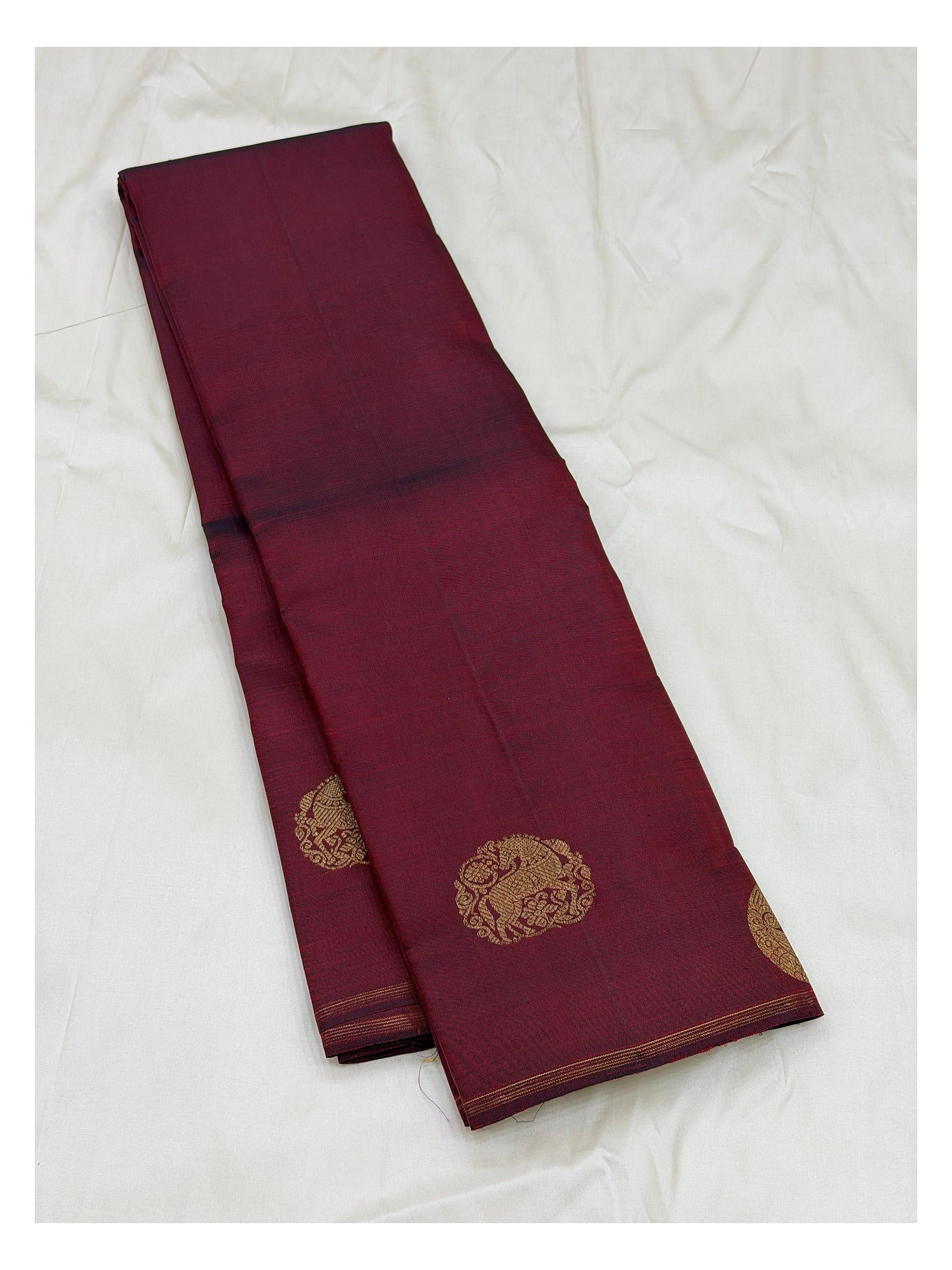 Folded view of deep wine handwoven Kanchipuram silk saree with pure zari detailing