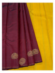 Deep wine handwoven Kanchipuram silk saree paired with bright contrast yellow section and gold-toned motifs