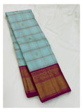 Full folded view of handwoven Kanchipuram silk saree in ice blue checks with magenta border