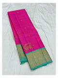 Folded view of the pink handwoven Kanchipuram silk saree with aqua zari border and buttas.
