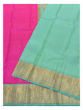 Spread view showing the aqua pallu, gold zari border and pink body of the handwoven Kanchipuram silk saree.