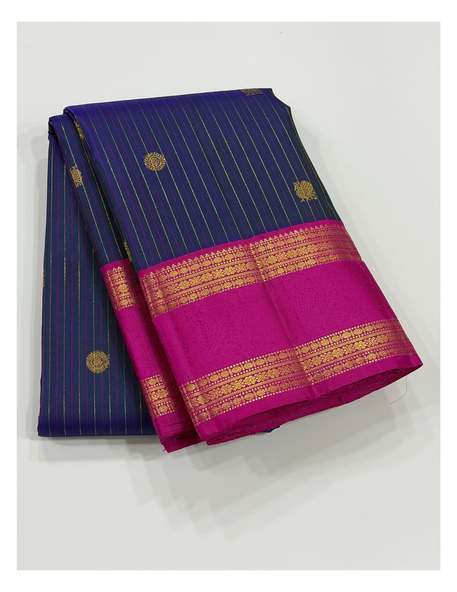 Handwoven Kanchipuram silk saree in deep blue with pink zari border folded display