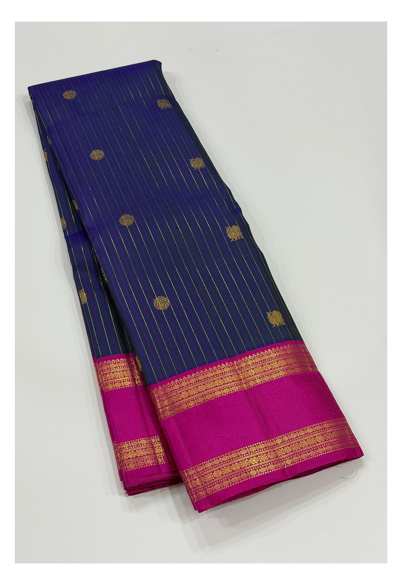 Deep blue Kanchipuram silk saree with pink contrast border and zari stripes