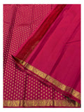 Rani pink Kanchipuram silk saree opened to show zari pallu and gold buttas