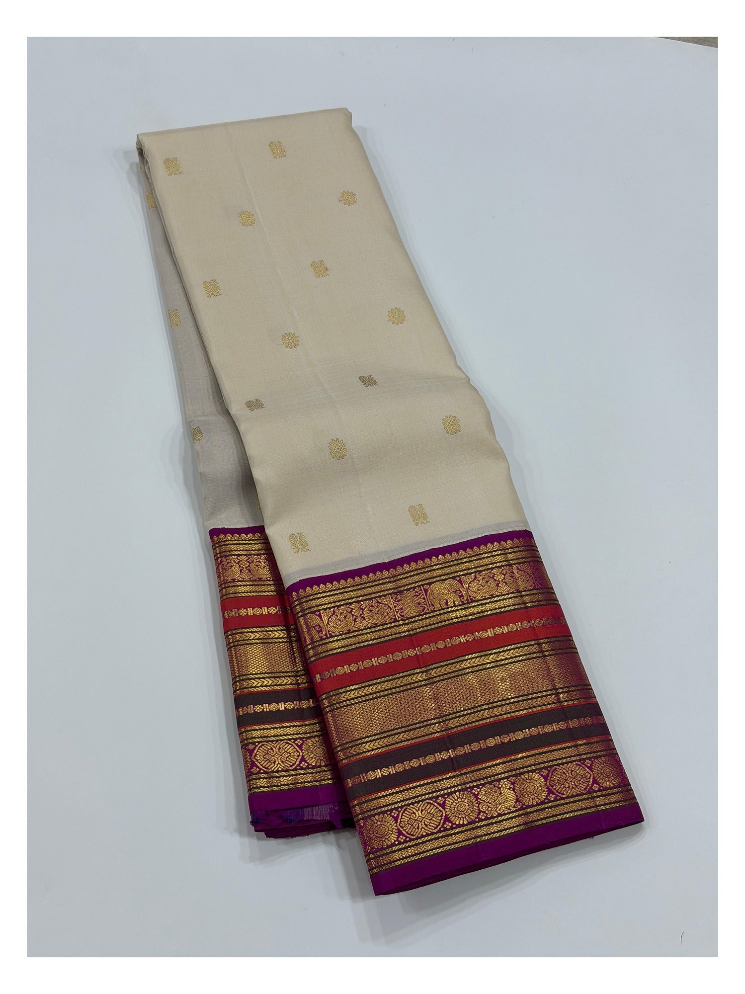 Ivory saree body with small woven butta motifs and magenta contrast border