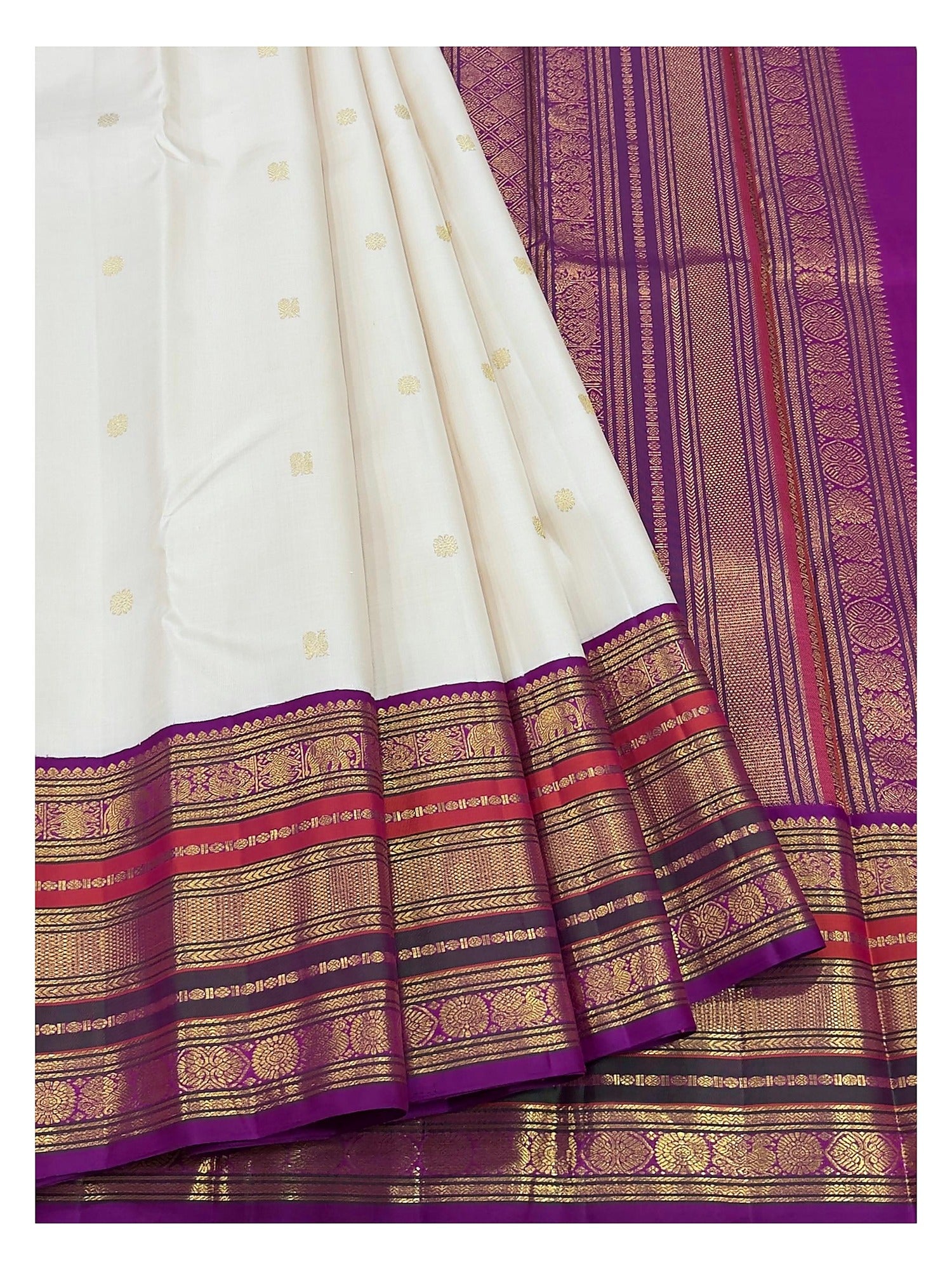 Detailed view of the ivory saree border and magenta pallu with gold-toned woven motifs