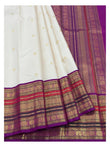 Detailed view of the ivory saree border and magenta pallu with gold-toned woven motifs