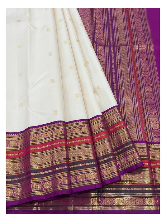 Detailed view of the ivory saree border and magenta pallu with gold-toned woven motifs