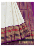 Detailed view of the ivory saree border and magenta pallu with gold-toned woven motifs