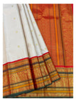 Pleated view of the saree showing blush pink body, ornate red pallu, and broad gold-toned border