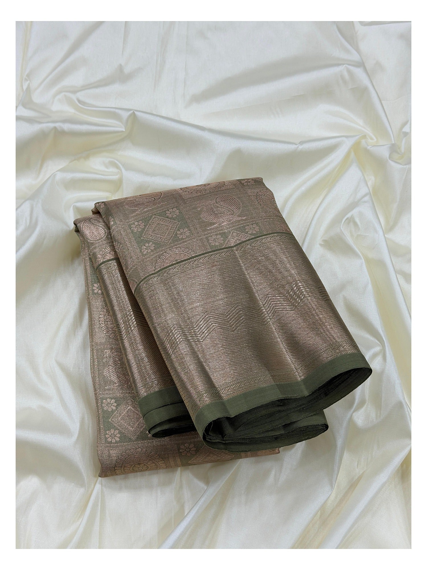 Handwoven Kanchipuram silk saree in sage green with antique gold woven detailing and dark olive edging, folded view