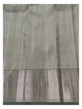 Close view of sage green saree body with fine geometric weave and broad antique gold zari border
