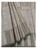 Detailed view of handwoven Kanchipuram silk saree showing motif panels and antique gold woven border