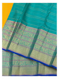 Close view of the teal pallu and broad woven motif border with mustard body contrast