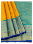 Draped mustard saree with teal patterned pallu and broad woven border panels